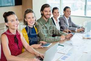 Smiling business team sitting in conference room