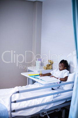 Patient writing on the book while sitting
