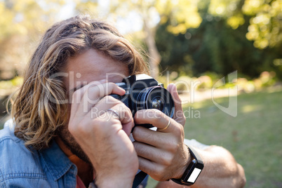 Man taking picture with digital camera