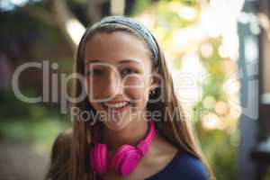 Portrait of happy schoolgirl with headphones