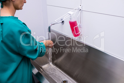 Female surgeon washing her hands