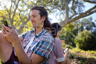 Young couple text messaging on mobile phone