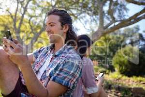 Young couple text messaging on mobile phone