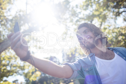 Smiling man taking a selfie on mobile phone