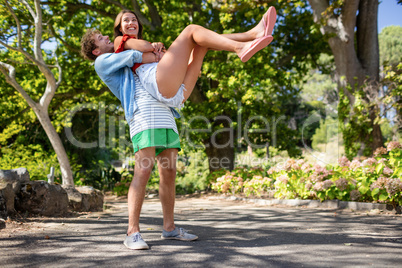 Man carrying woman in park