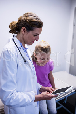 Doctor showing medical report in digital tablet to patient