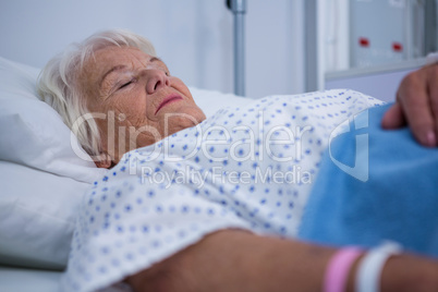 Senior patient lying on bed