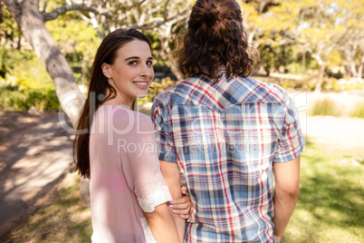 Couple holding hands in park