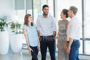 Architects discussing with each other in office