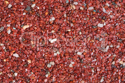 Red stone texture close-up horizontal background.