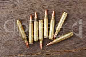 Bullets on rustic wooden background.