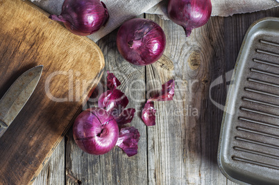 Red onion vegetable on the gray wooden surface