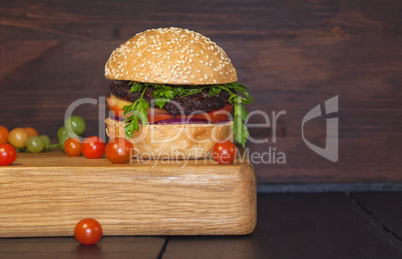 Meat sandwich sesame bun on a kitchen board