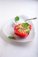 Stuffed red peppers filled with quinoa and vegetables.