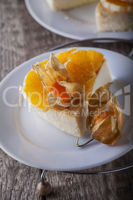 Cheesecake decorated with oranges and physalis
