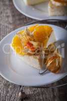 Cheesecake decorated with oranges and physalis