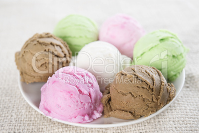 Assorted ice cream scoops on plate.