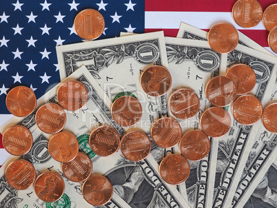 Dollar notes and coins and flag of the United States