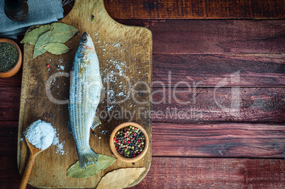 Fresh fish smelt spices for cooking on a kitchen board