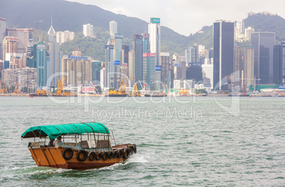 Traditional Boat in front of Hong Kong Harbour Skyline