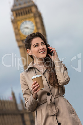 Woman Drinking Coffee Using Cell Phone, Big Ben, London, England