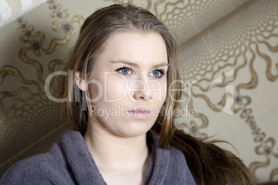 Young woman looks expressionless