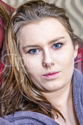 Young woman looks expressionless