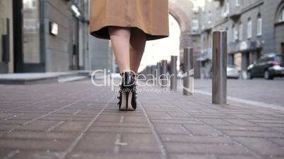 Woman wearing black high heels shoes walking away