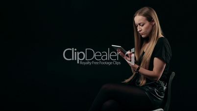 Cute young woman shopping online with touchpad