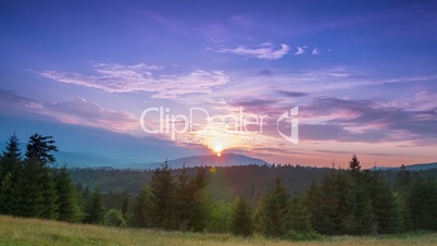 Sunset in the Cloudless Sky over Wooded Mountains. Time Lapse
