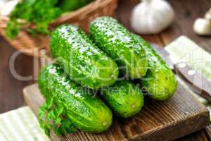 Fresh cucumbers on wooden background close up