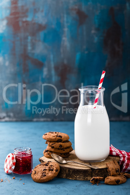 Milk in glass bottle on blue background, breakfast