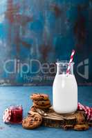 Milk in glass bottle on blue background, breakfast