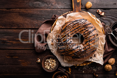 Chocolate brownie cake, dessert with nuts on dark background, top view