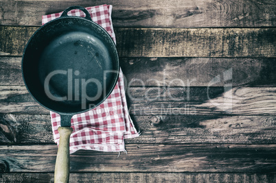 Empty frying pan on a textile napkin