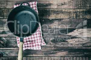 Empty frying pan on a textile napkin