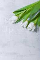 White tulips on wooden table