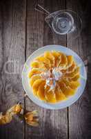 Cheesecake decorated with oranges and physalis