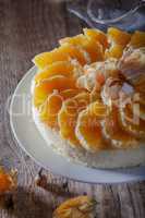 Cheesecake decorated with oranges and physalis.