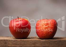 Two red apples on table