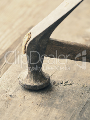 Old used hammer on wood