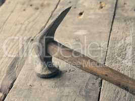 Old used hammer on wood