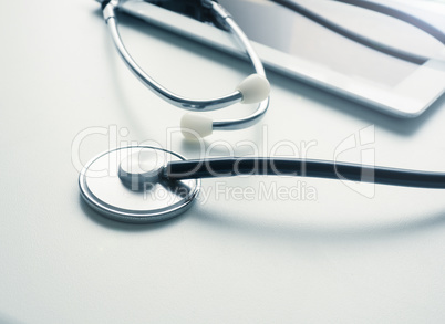 Stethoscope with tablet computer on table
