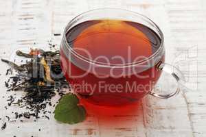 Tea. Herbal tea. Mint leaf. Tea in a glass cup, mint leaves, dried tea, sliced lime. herbs on a slate plate in a restaurant or teahouse