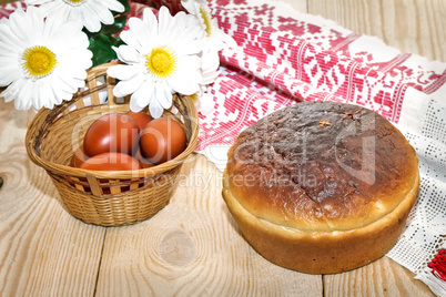 Easter eggs, cake and artificial flowers.