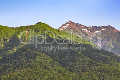 The mountainous landscape of the slopes covered by forest.