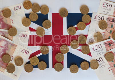 Pound coins and notes, United Kingdom over flag