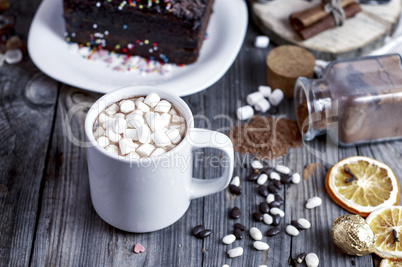 Cocoa with marshmallow on a gray wooden surface