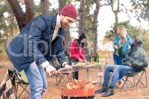 Man kindling fire on grill