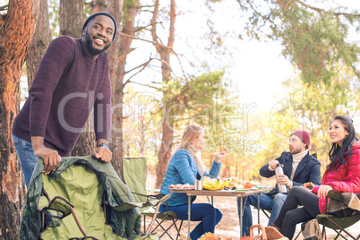 Smiling friends having fun in campsite